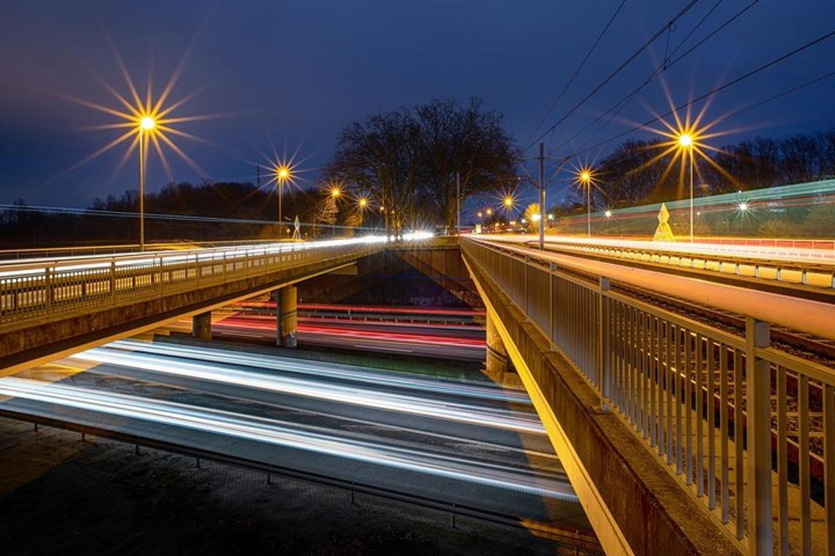 a city street with lights on a bridge at night