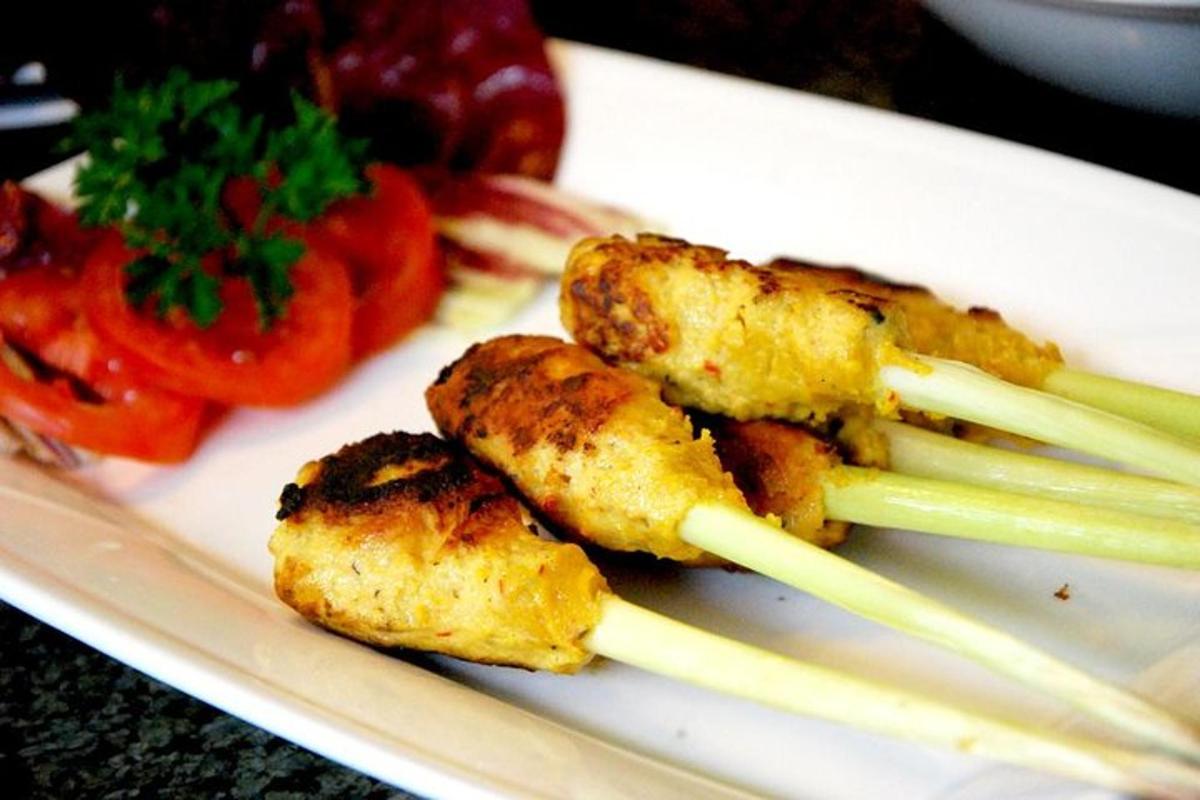 a plate of food with chop sticks and vegetables
