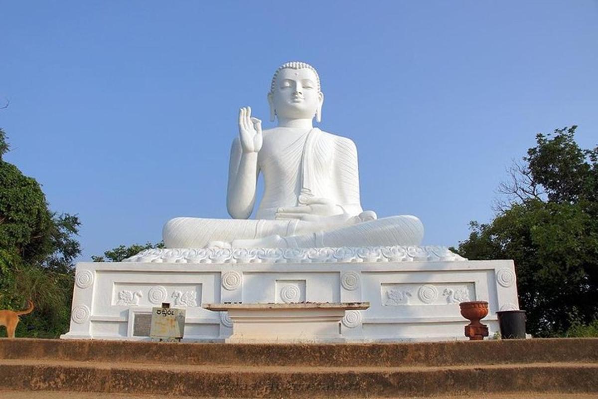 a large white statue sitting on top of some stairs