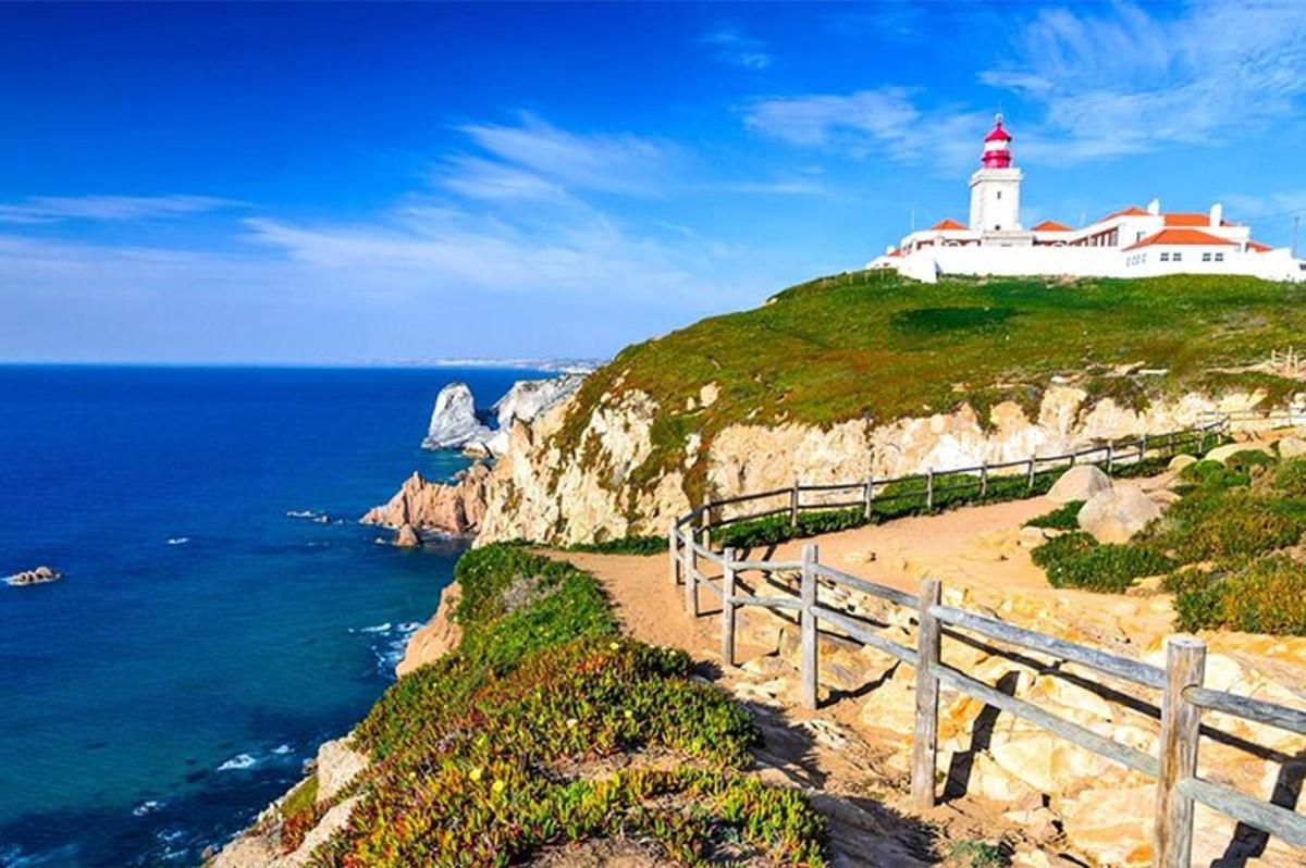 a lighthouse on top of a cliff next to the ocean