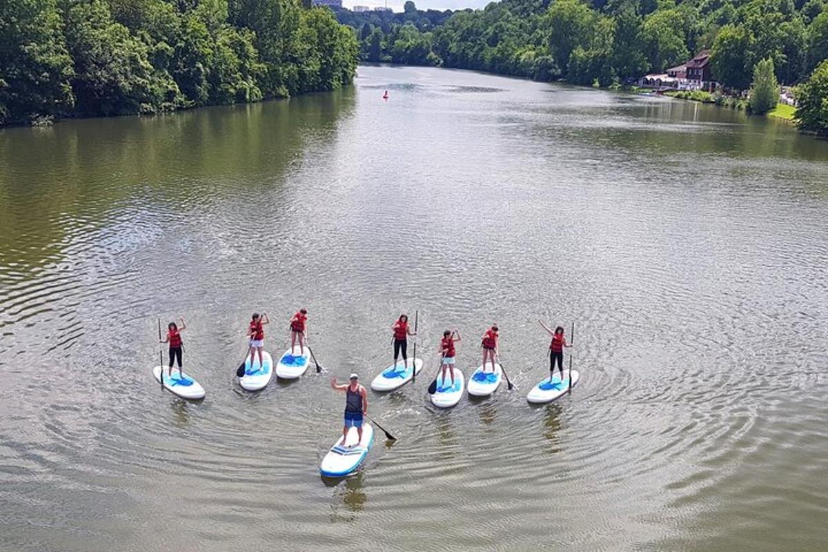 a group of people on paddle boards on a river