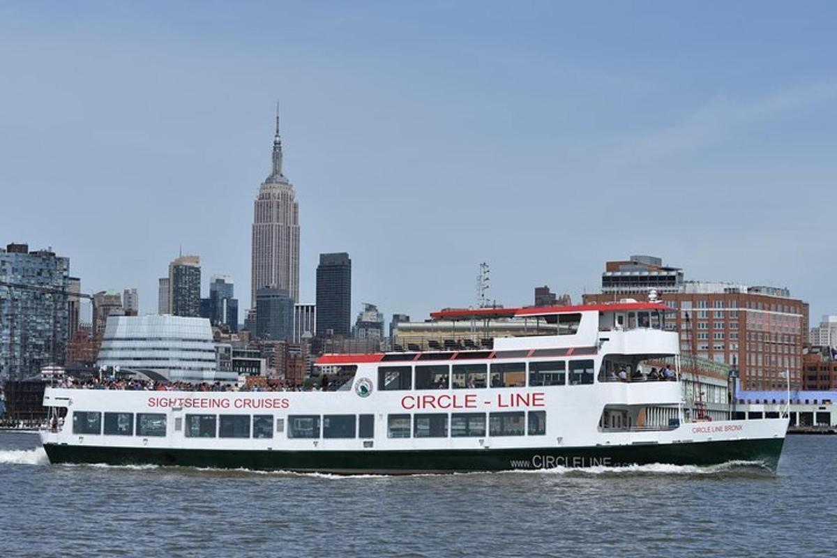 a cruise ship on the water with a city in the background