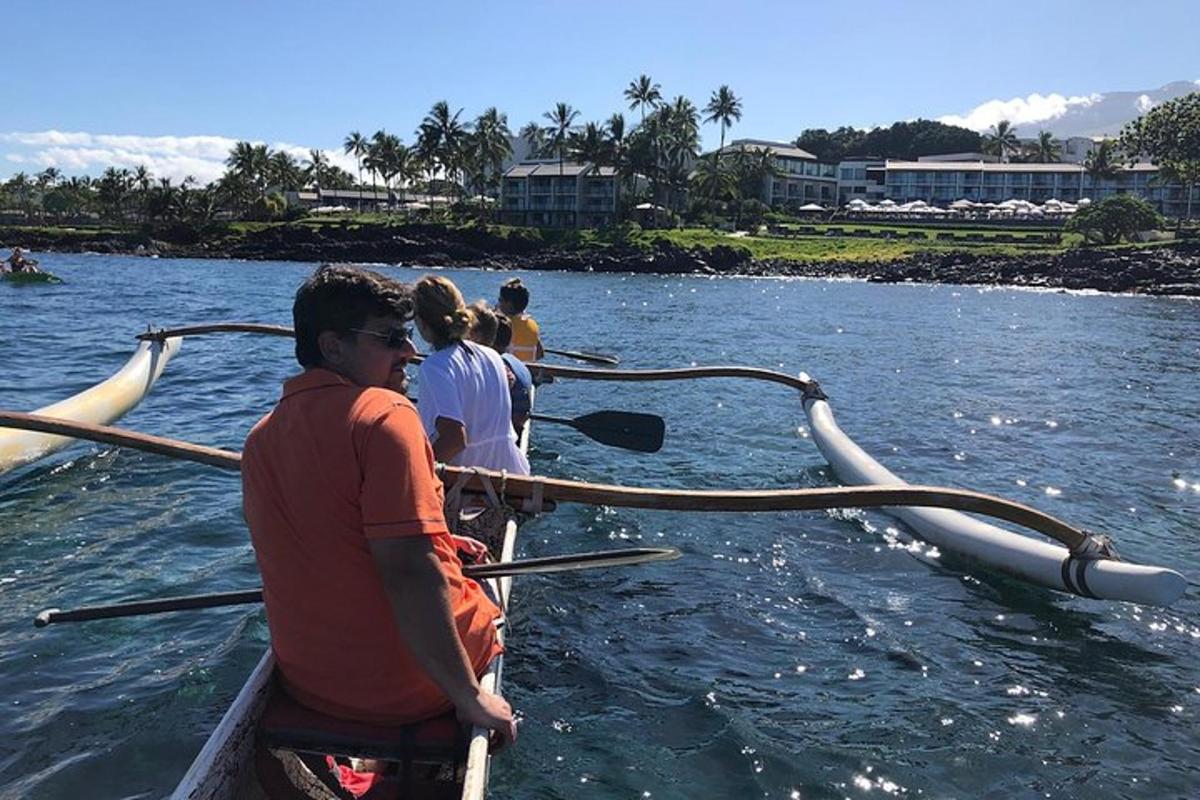 a group of people in a boat in the water