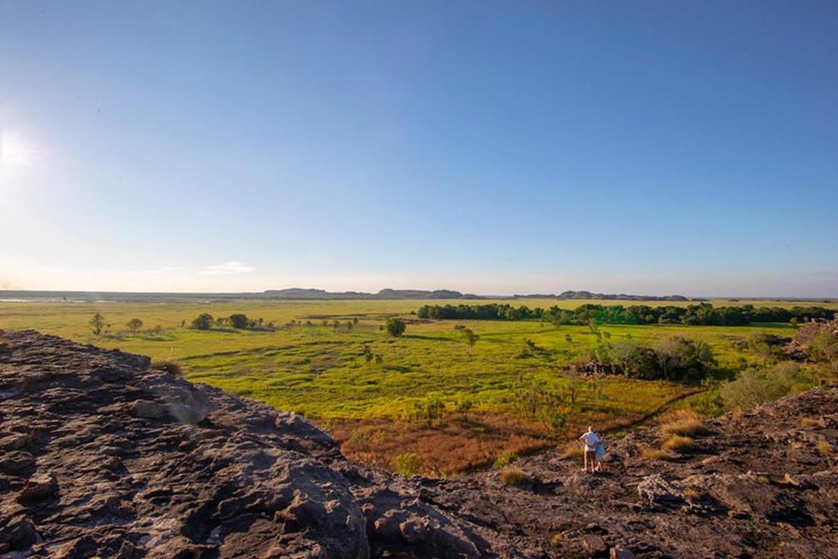 a person standing on top of a rocky hill