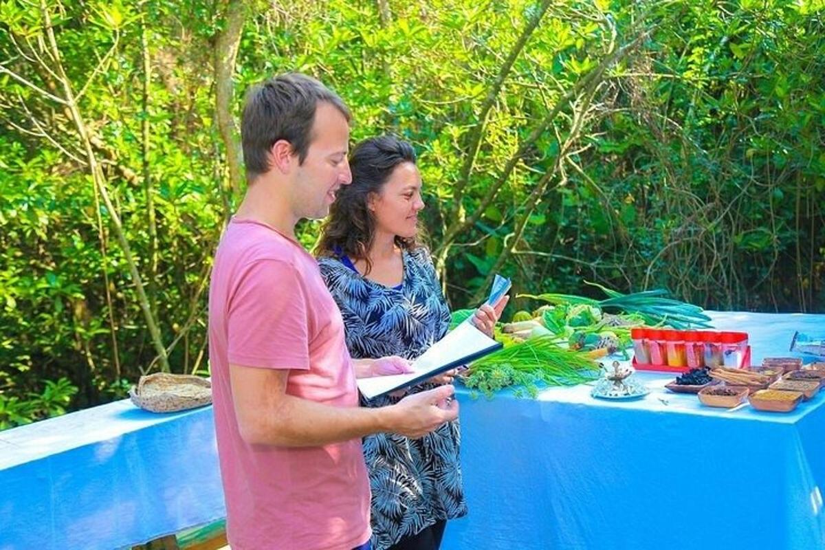 a man and a woman standing next to a table with food