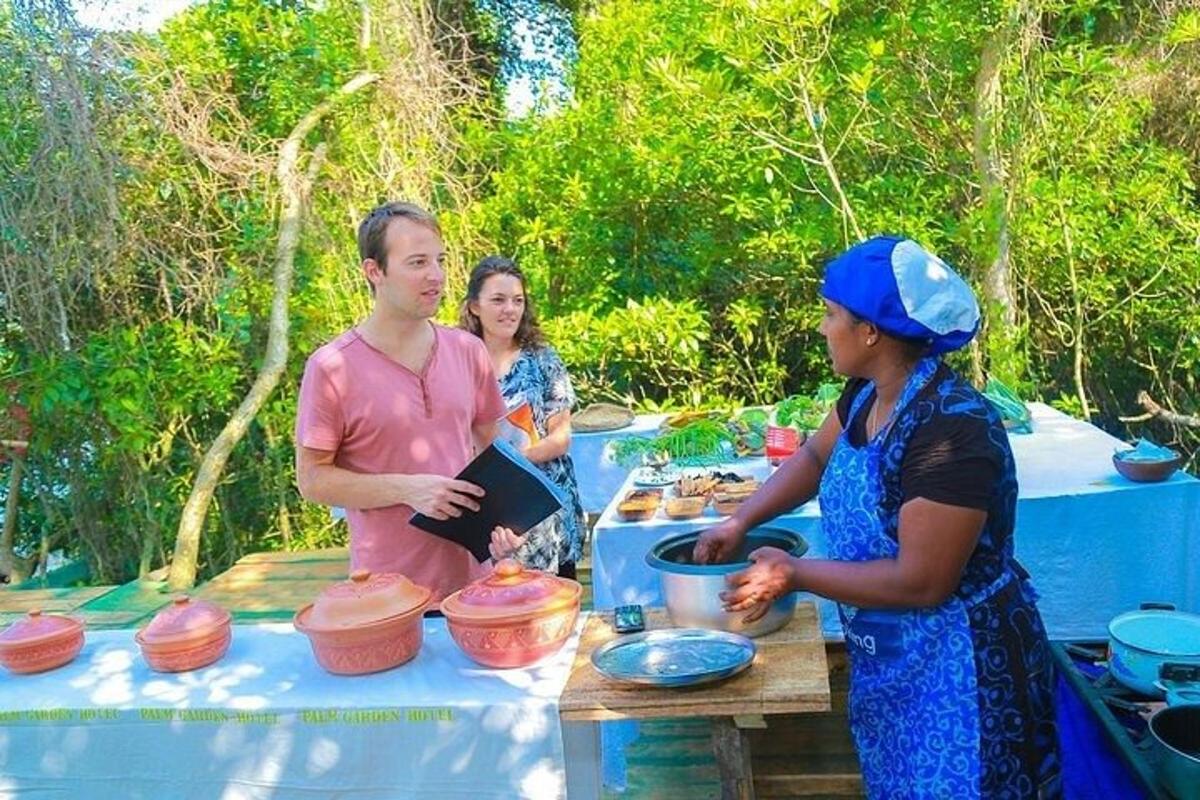 a group of people standing around a table with food