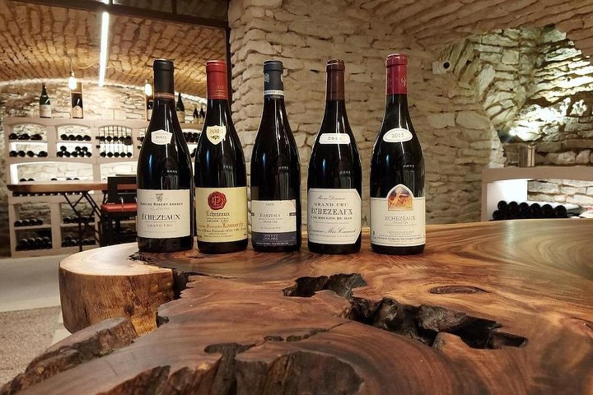 four bottles of wine sitting on a wooden table