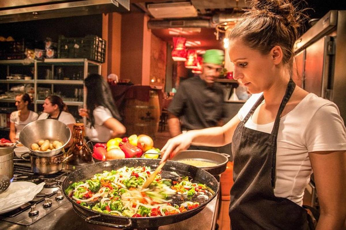 a woman in a kitchen preparing a pan of food