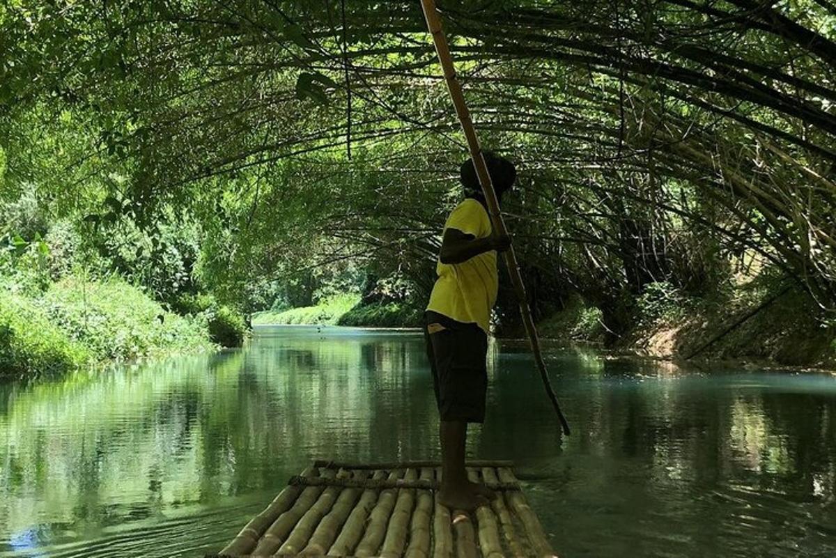 a man standing under a bridge over a river