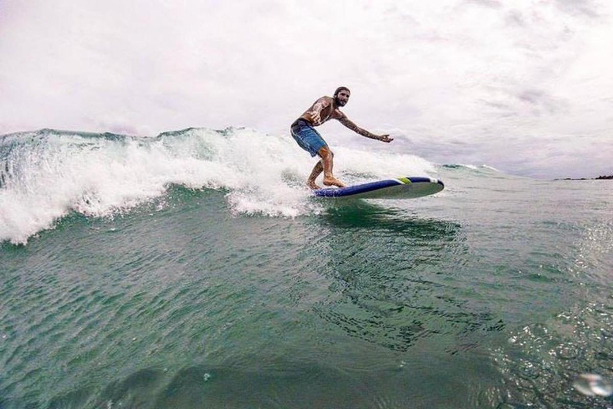 a man riding a wave on a surfboard in the ocean