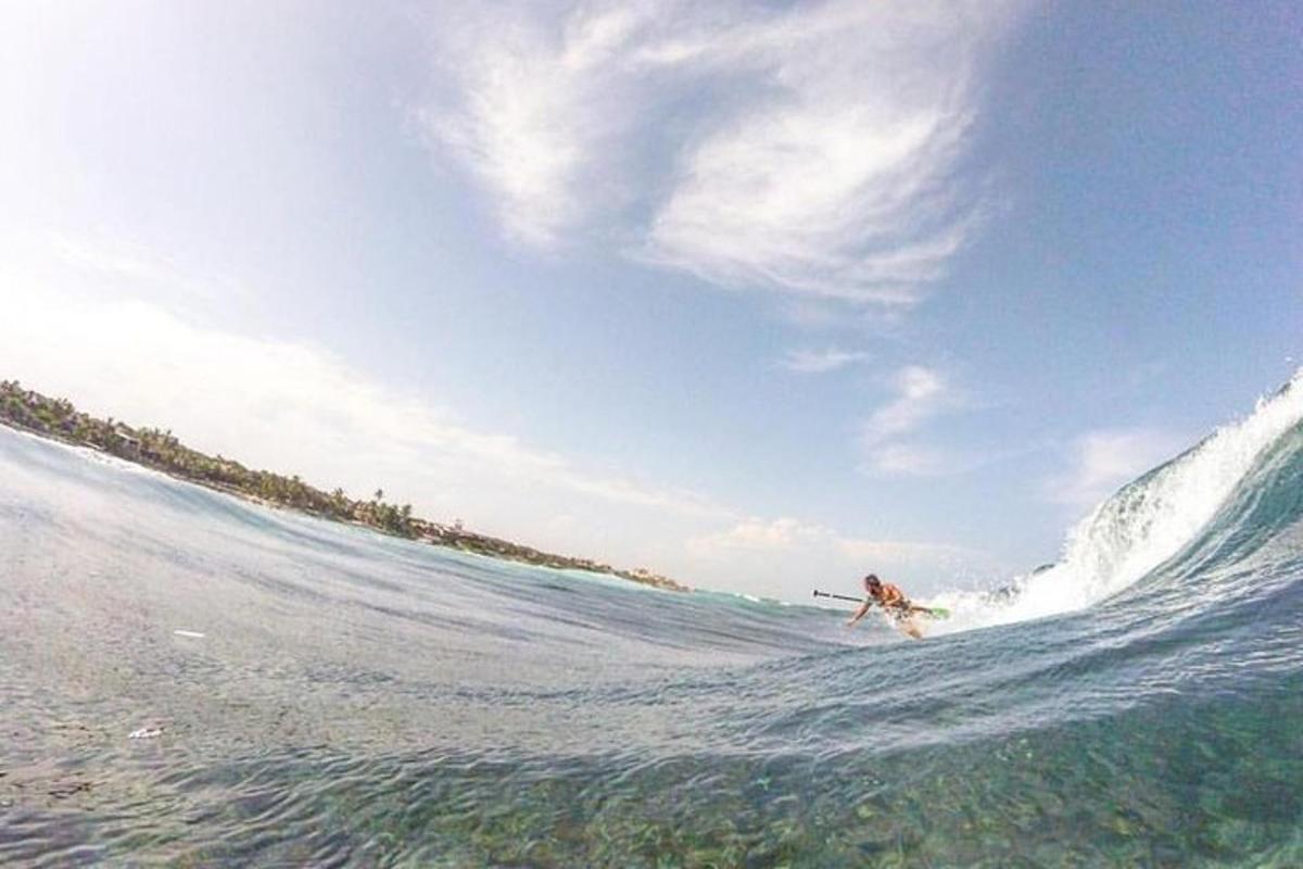 a person riding a wave on a surfboard in the ocean