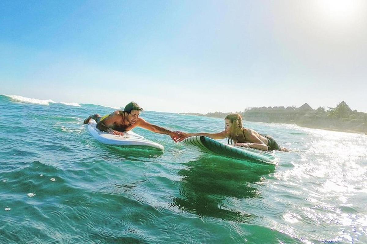 two men are on their surfboards in the ocean