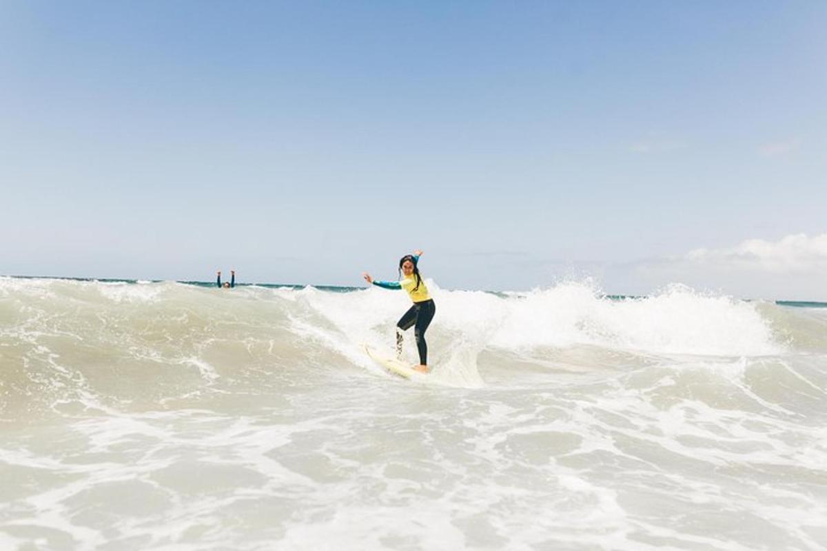 een vrouw die op een surfplank op een golf in de oceaan rijdt