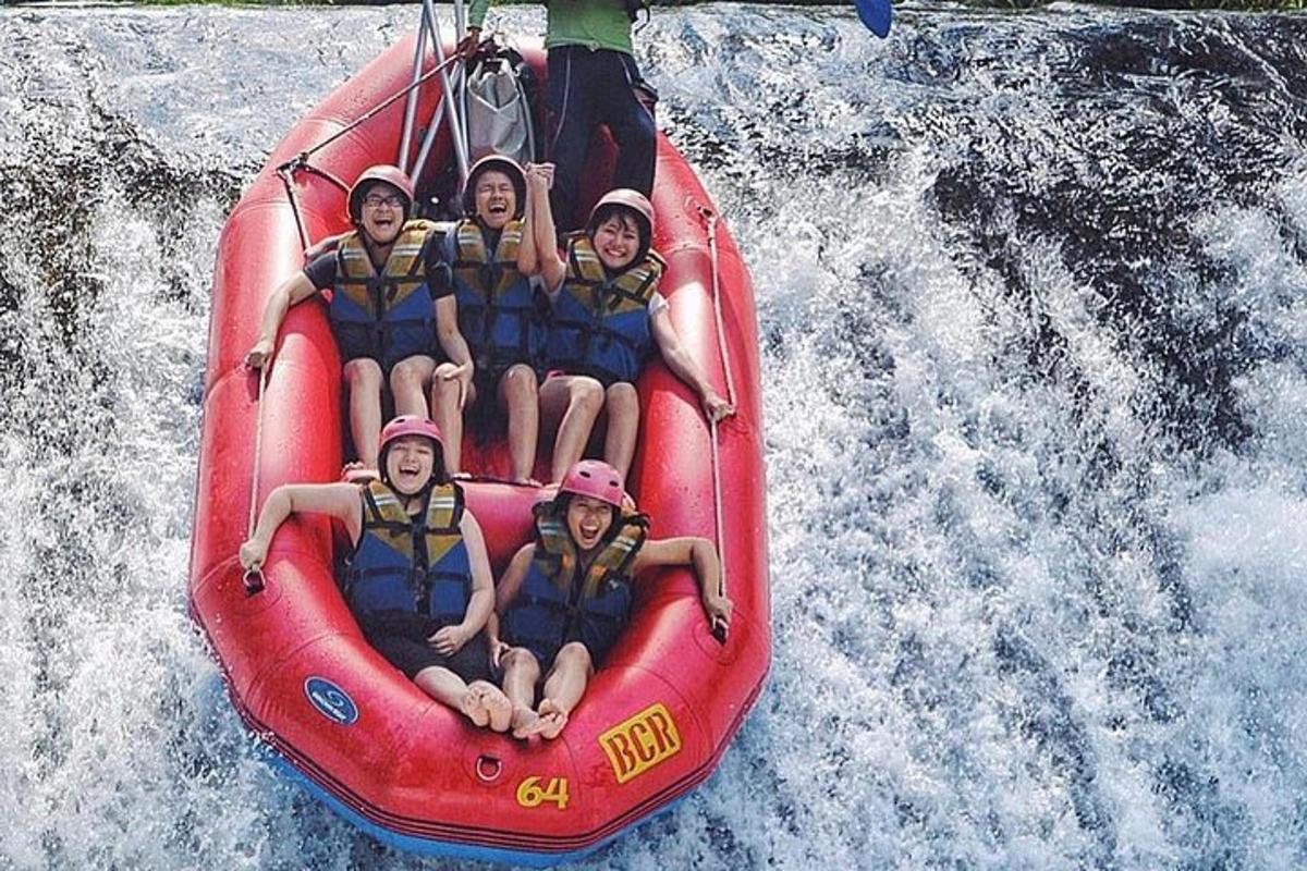 a group of people riding on a raft in the water