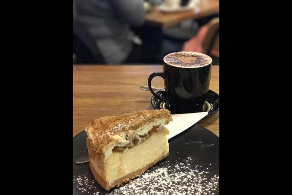 et kakestykke og en kopp kaffe på et bord