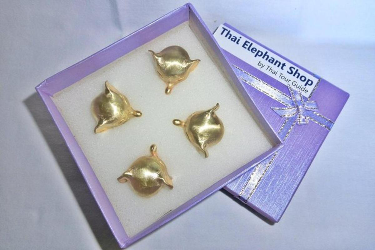 a purple box with five gold earrings in it