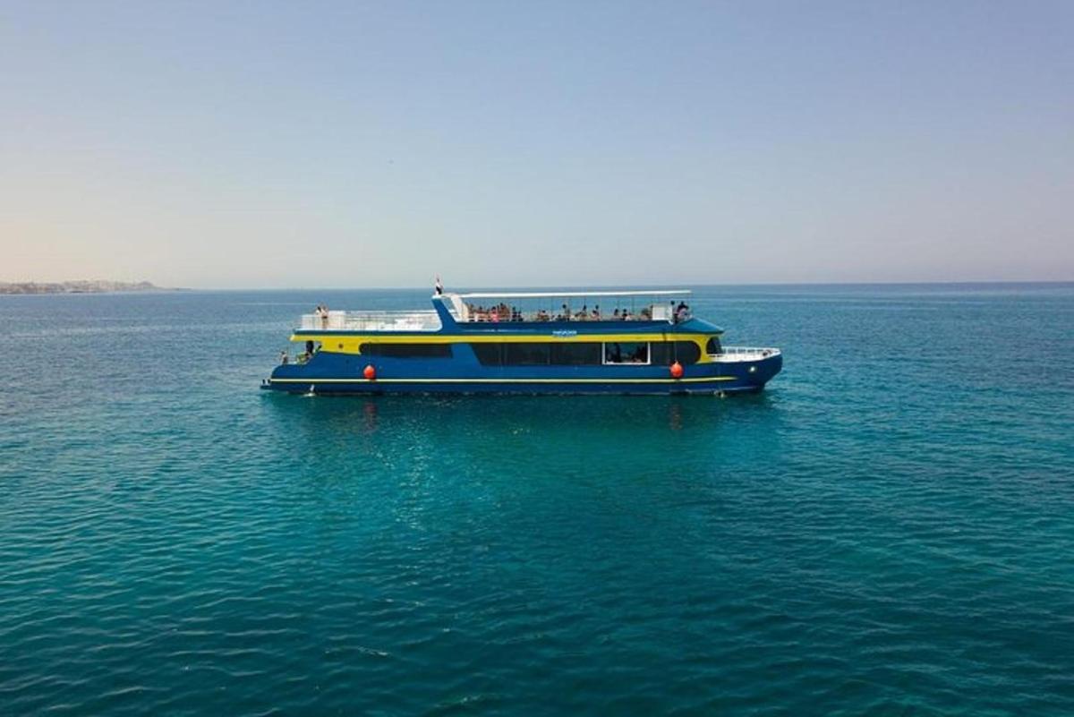 a blue and yellow boat in the middle of the water