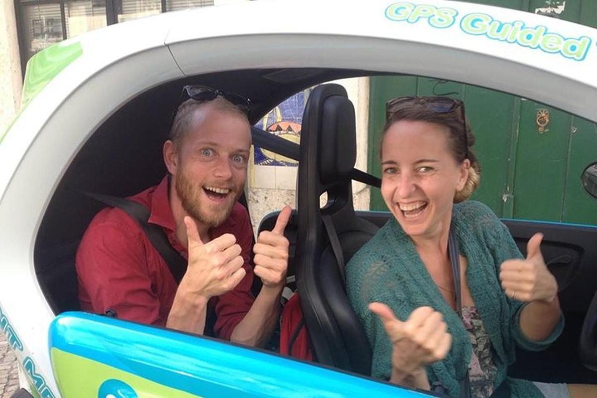 a man and a woman giving thumbs up in a car