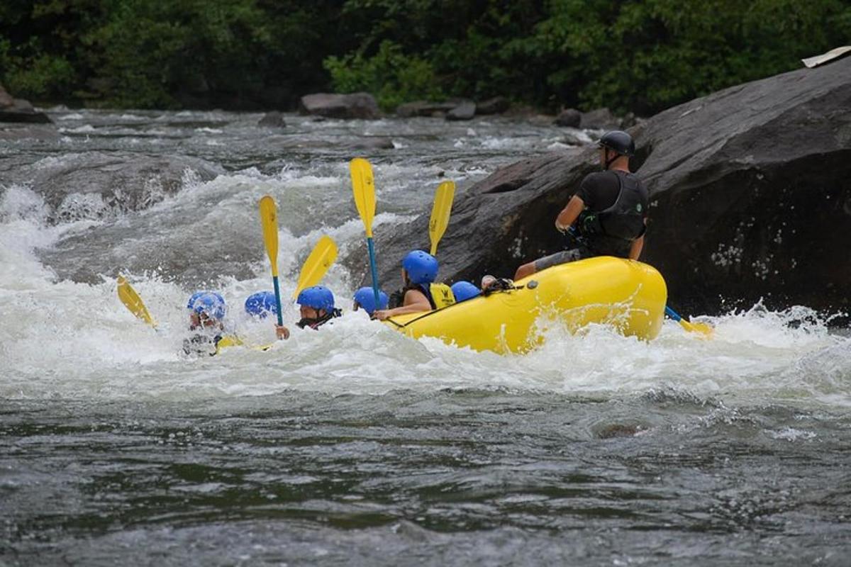 a group of people in a raft in a river