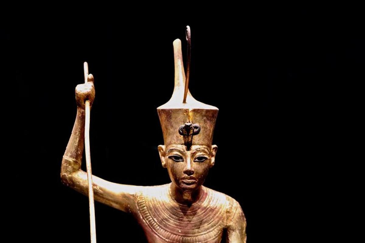 en guldstatue af en kvinde, der holder et spyd