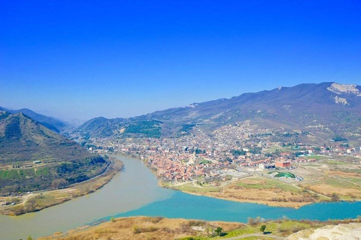 an aerial view of a town next to a river