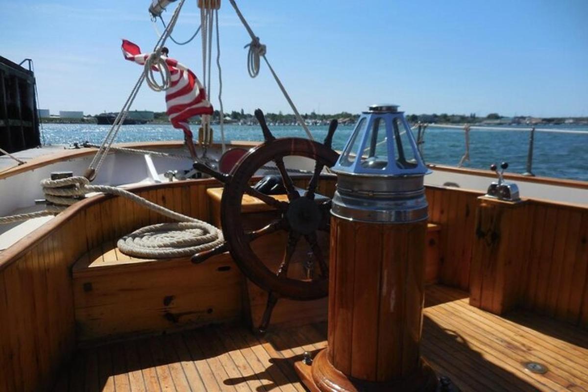 a boat with a steering wheel and an american flag