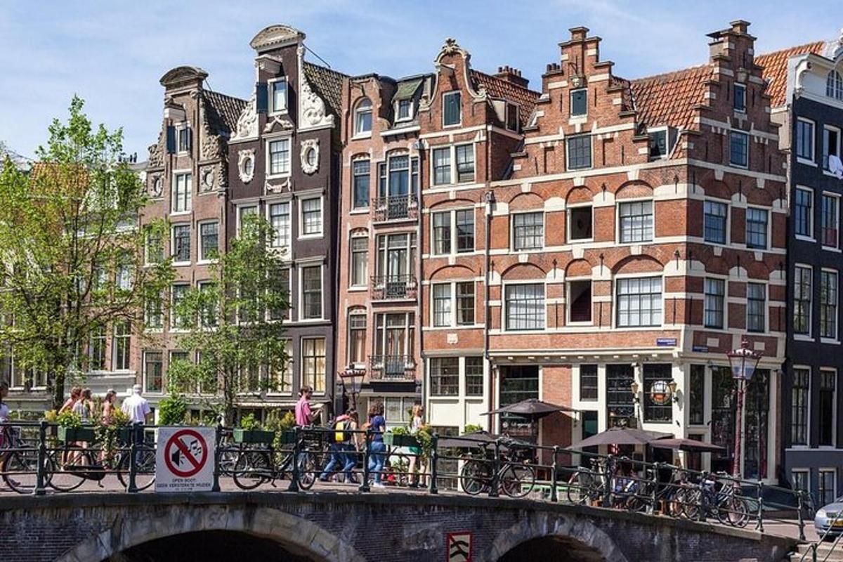 a bridge over a river in front of buildings