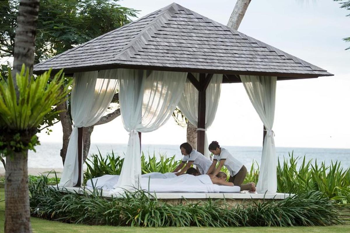 two people sitting on a bed in a gazebo