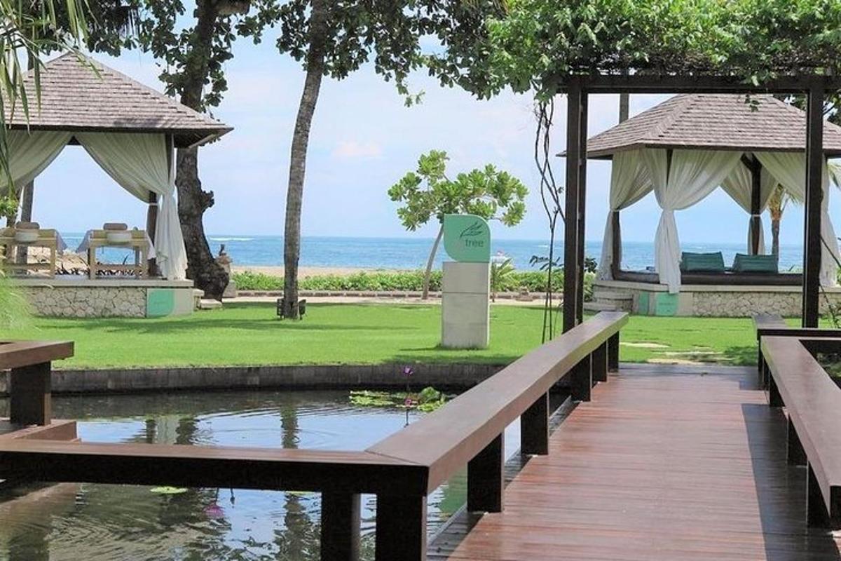 a wooden bridge over a pond in a resort