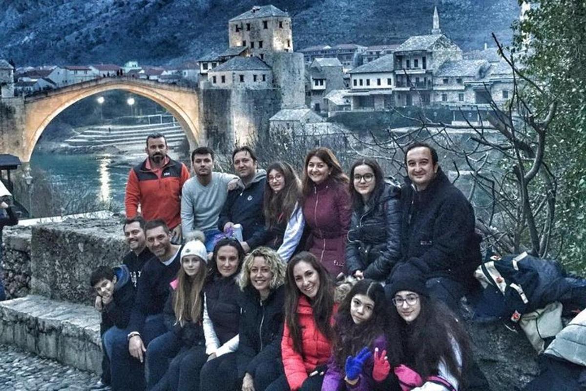 a group of people posing in front of a castle