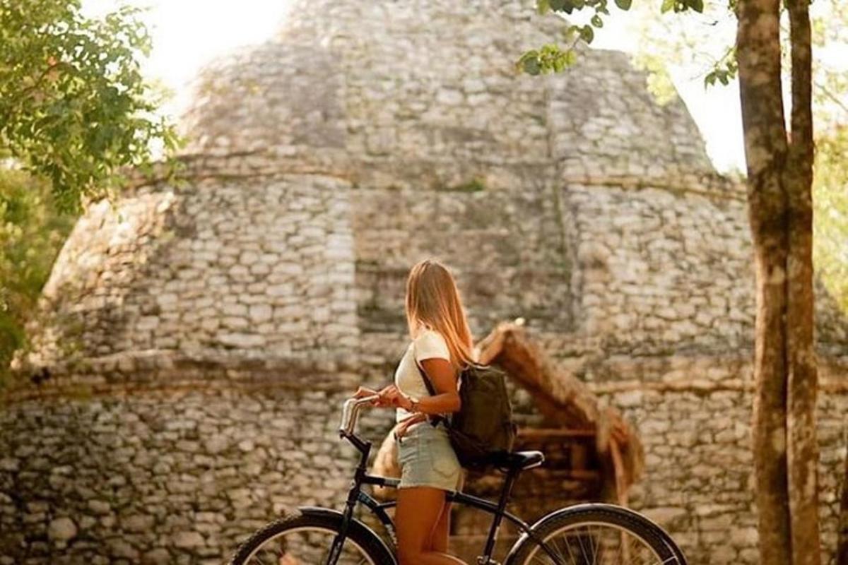 a woman riding a bike in front of a building