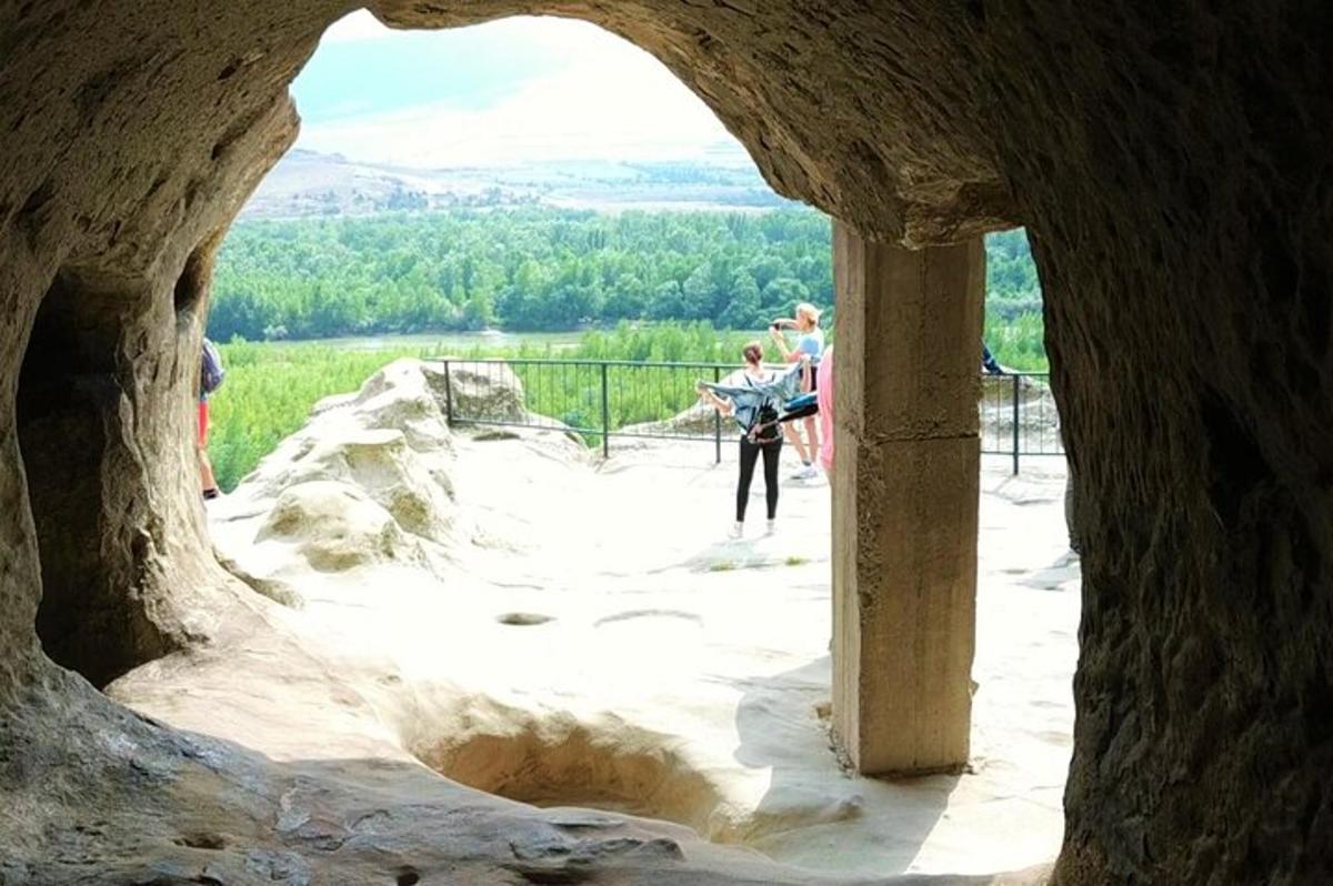 μια ομάδα ανθρώπων που στέκονται σε μια πέτρινη αψίδα