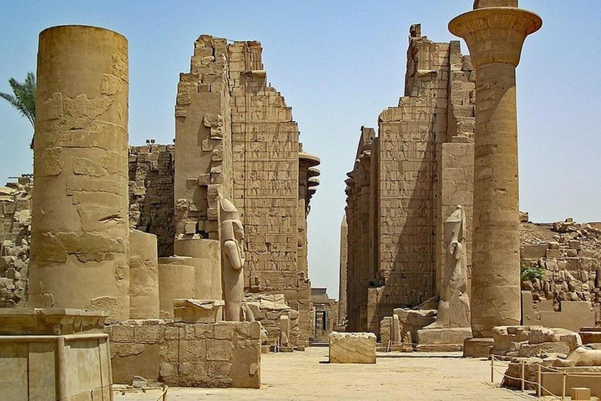 a group of ancient ruins with columns and a pillar