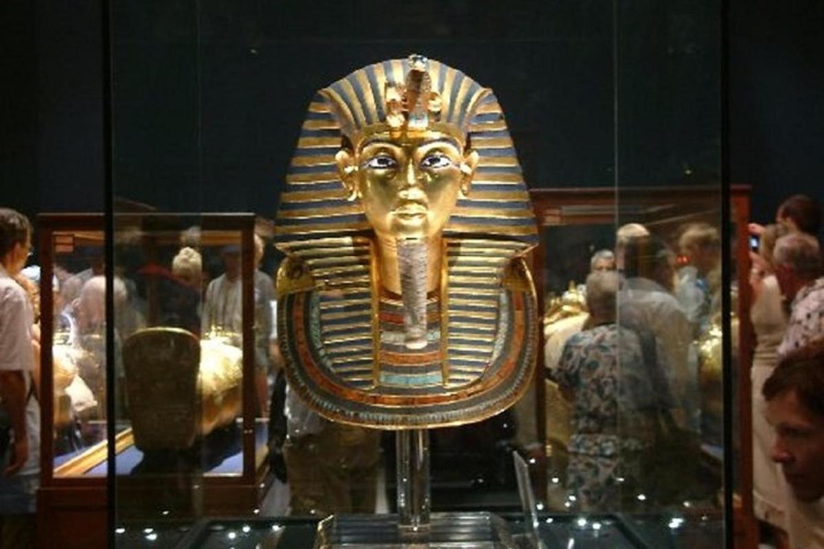 a golden mask in a display case in a museum