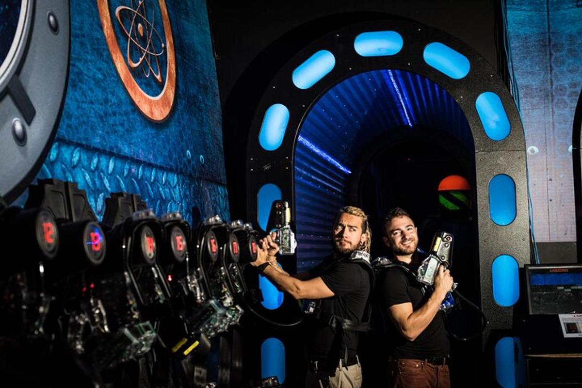 two men taking pictures with their cell phones in a room