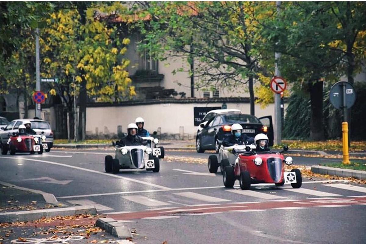 a group of people riding inpelledpelled cars on a street