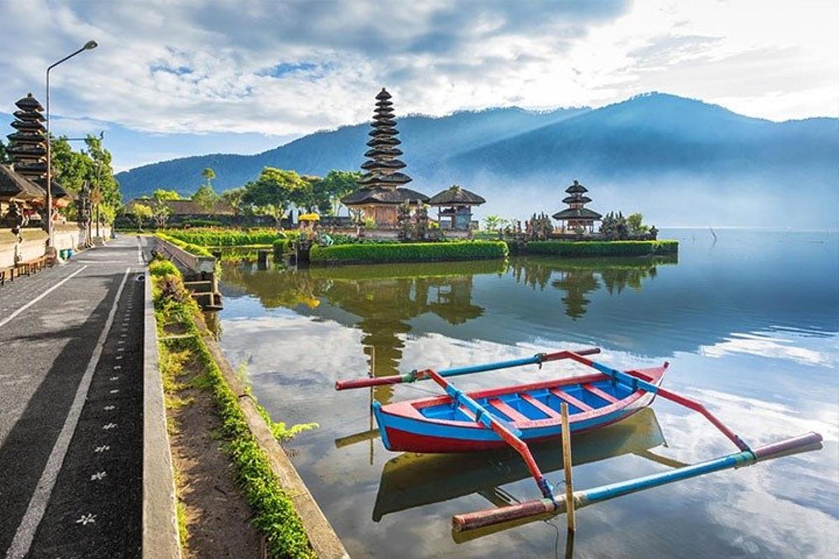 a boat sitting in the water next to a street