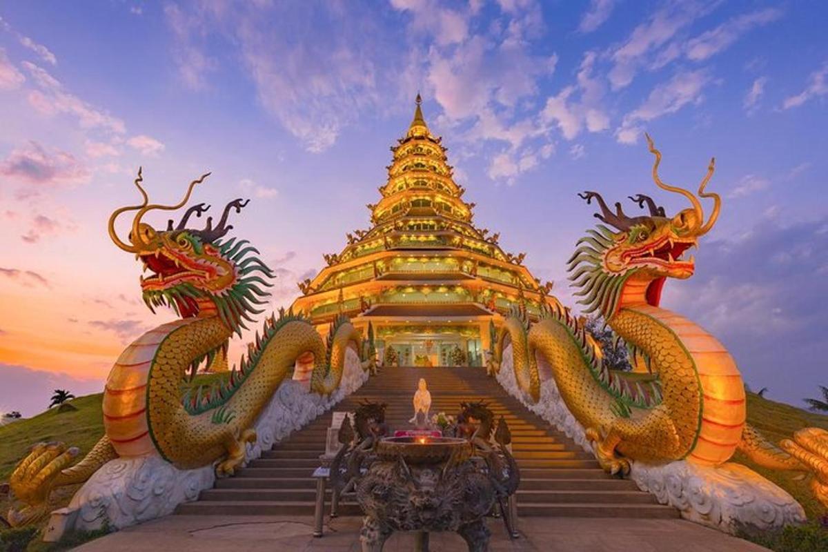 a pagoda with two dragons on the stairs