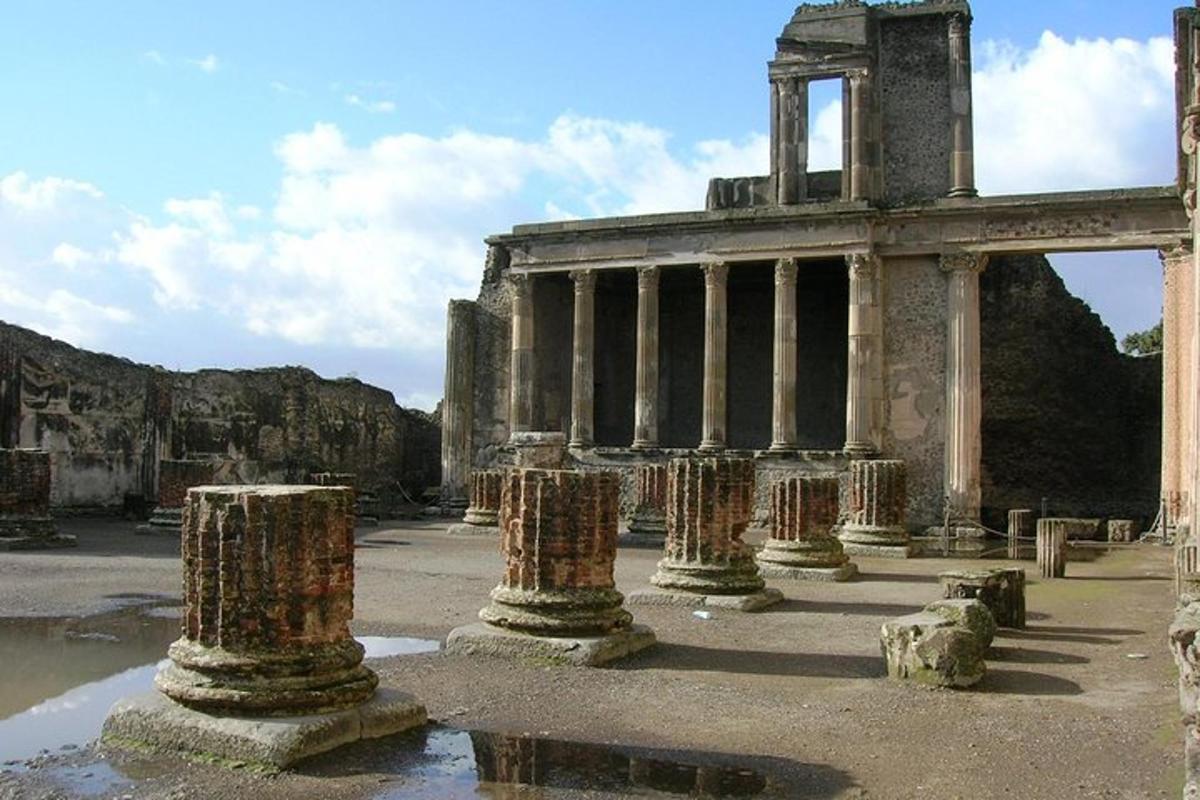 an ancient building with pillars in front of it