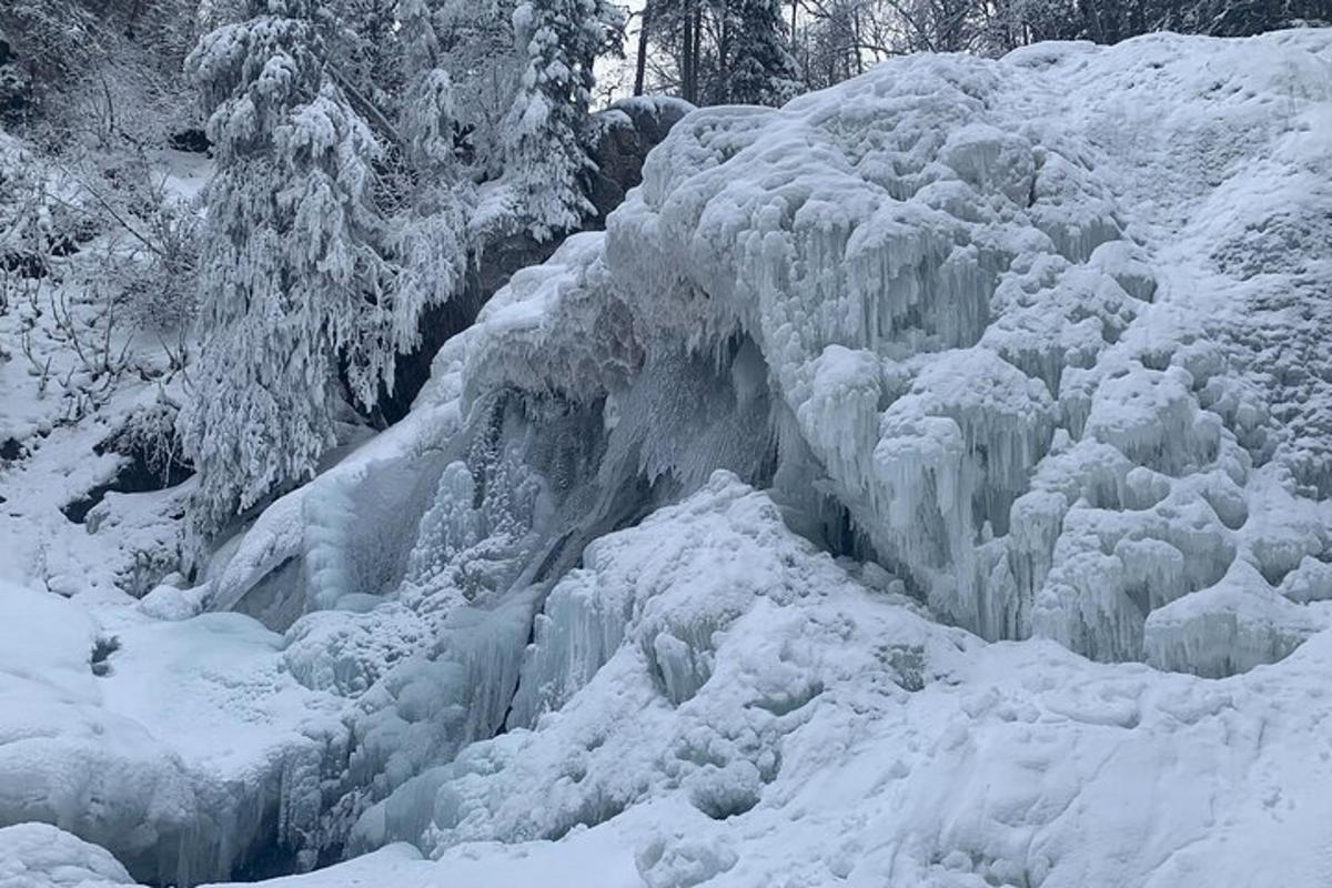 a frozen waterfall is covered in snow