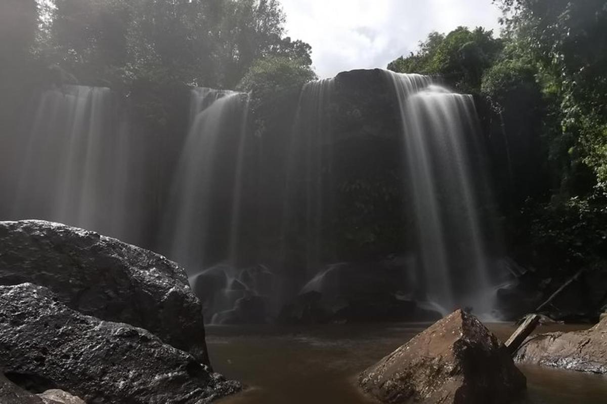 a waterfall in the middle of a pool of water