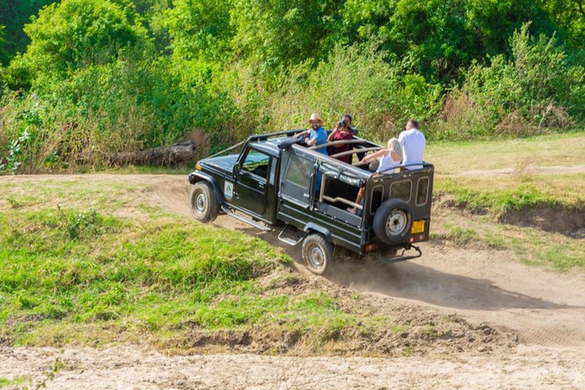 a group of people riding in the back of a jeep