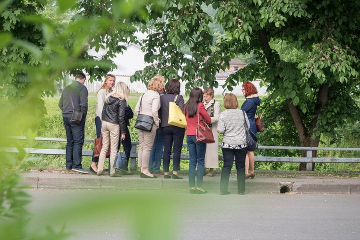 a group of people standing next to a fence