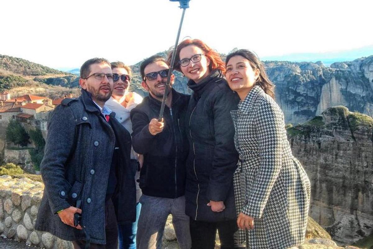 a group of people posing for a picture at the grand canyon