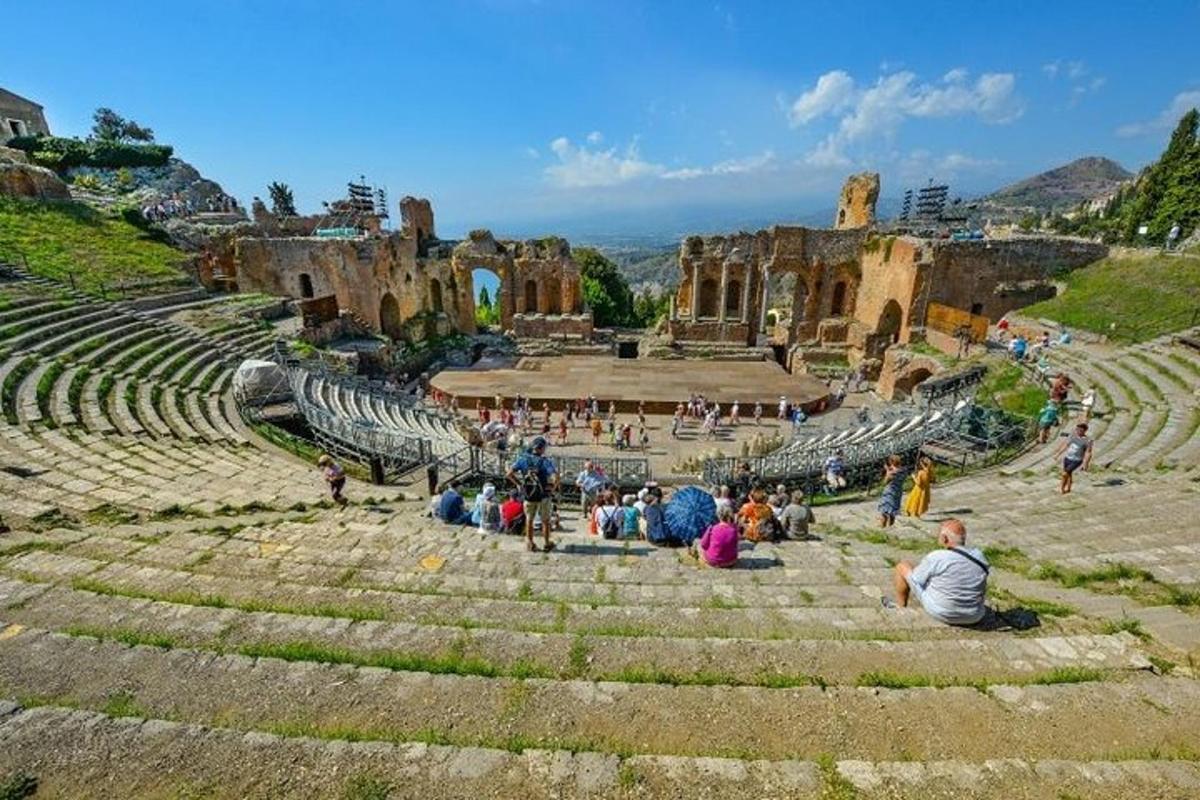 un gruppo di persone sedute sui gradini di un anfiteatro