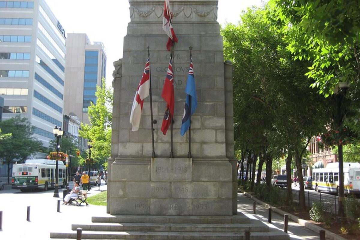two british flags on a monument in a city
