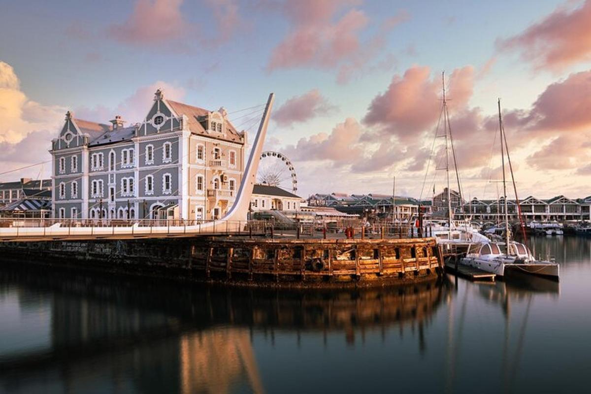 a large building and boats in the water with a bridge