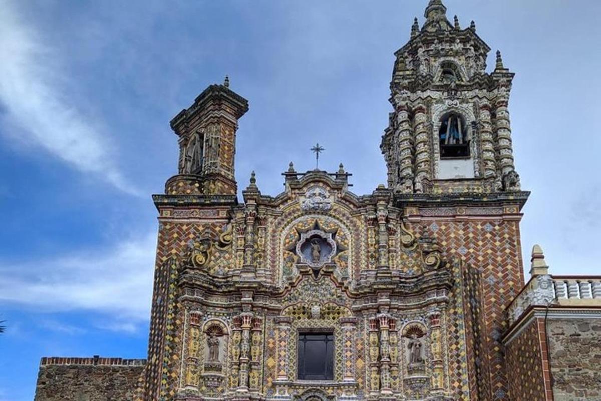 a large building with a tower and a cross on it