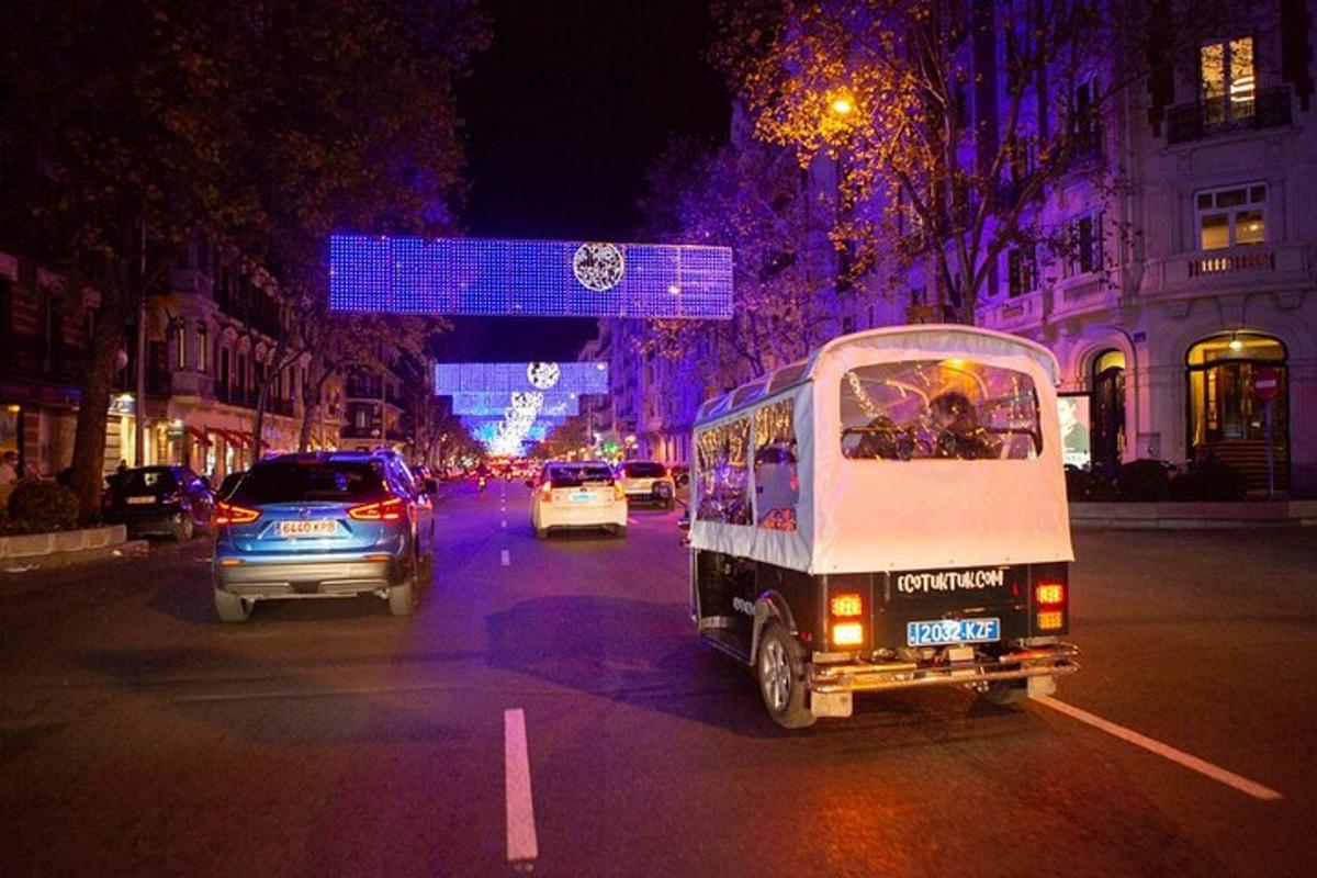 a small truck driving down a city street at night