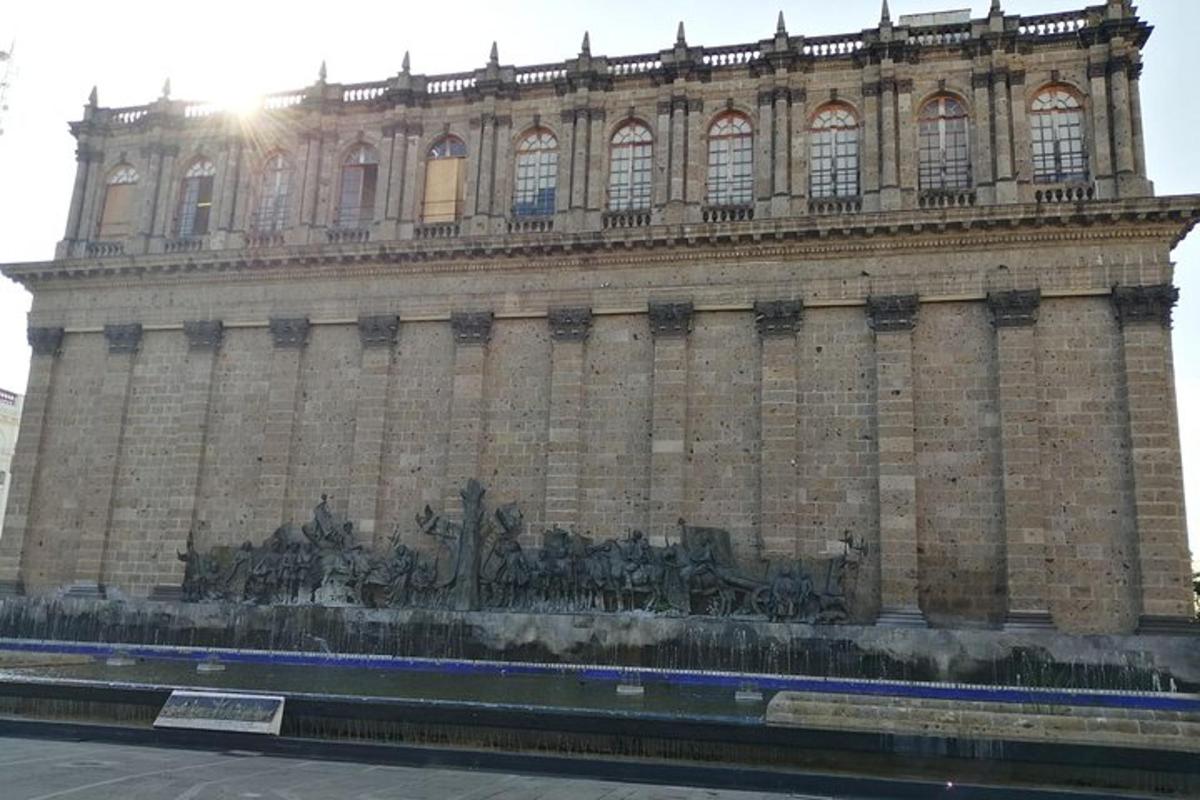 a large building with a statue in front of it